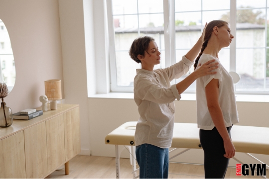 Female assisting another female with posture, helping to stretch neck muscles