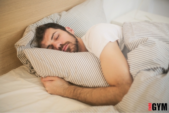 male lying in bed sleeping